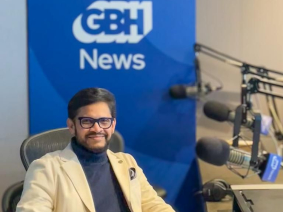 BAC President Mahesh Daas smiles as he waits to record an episode of The Culture Show in a GBH recording booth.