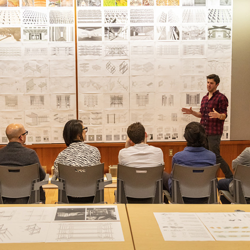 Students listen to a presentation.