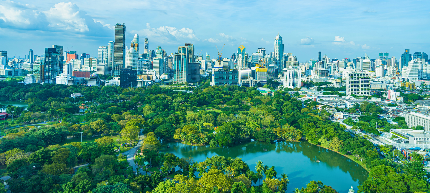 Beautiful landscape of Lumpini Park with the cityscape in the background of Bangkok, Thailand.