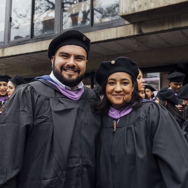 Two graduating students at the 2025 Commencement.