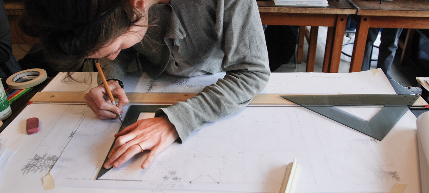 woman drawing lines with ruler