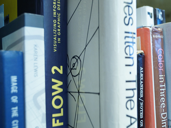 A close-up view of various books and textbooks on a bookshelf
