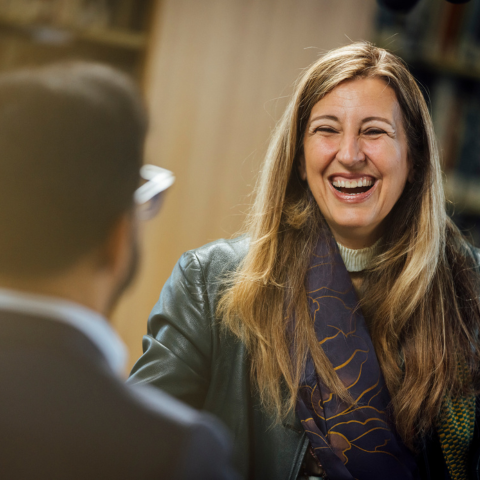 Benedetta Tagliabue speaks during a recorded conversation in the BAC library, gesturing while seated across from BAC President Mahesh Daas.