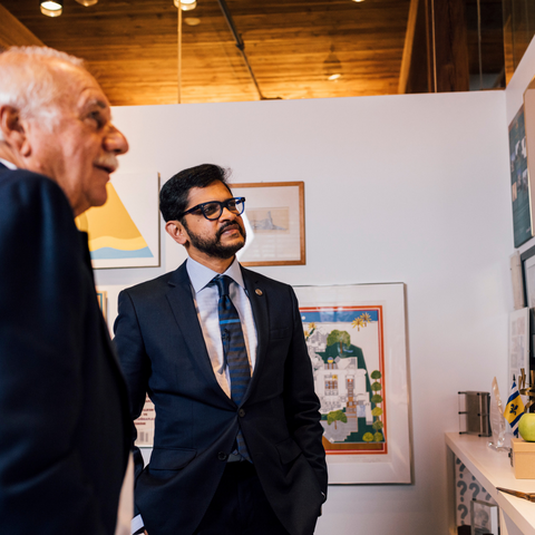 Architect Moshe Safdie and BAC President Mahesh Daas look over Safdie's wall of accolades and memories in his Boston office at Safdie Architects.