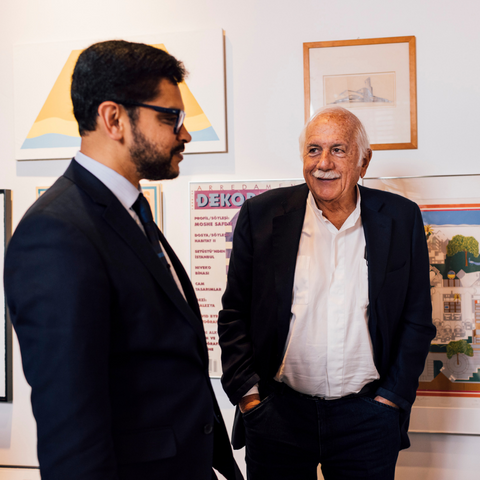 BAC President Mahesh Daas and Architect Moshe Safdie look over Safdie's wall of accolades and memories in his Boston office at Safdie Architects.