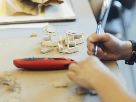 A BAC Summer Academy student works on carving items in studio.