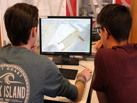Two summer academy students work together on a design project on the computer