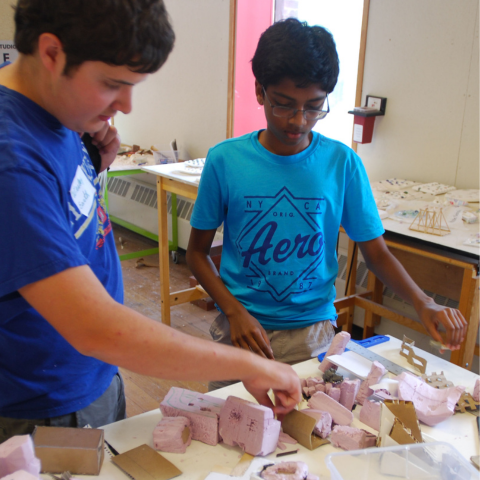 Students move around paper models at Summer Academy.