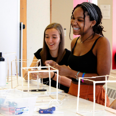 Summer Academy students have fun and laugh during a modeling project.