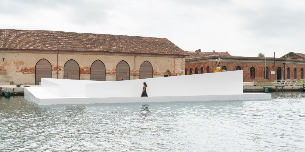 AquaPraça is a 400 m2 natant cultural plaza, pictured here at the Venice Biennale and later installed in Belém for COP30 as permanent cultural infrastructure. Floating at and dipping beneath the waterline, the pavilion negotiates buoyancy via air and water ballasts, turning the sea into a civic arena. Photo Credit: DSL Studio.