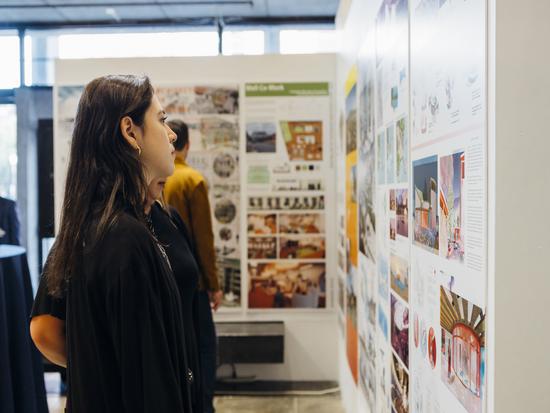A student views work at the 2022 Graduate Exhibit.