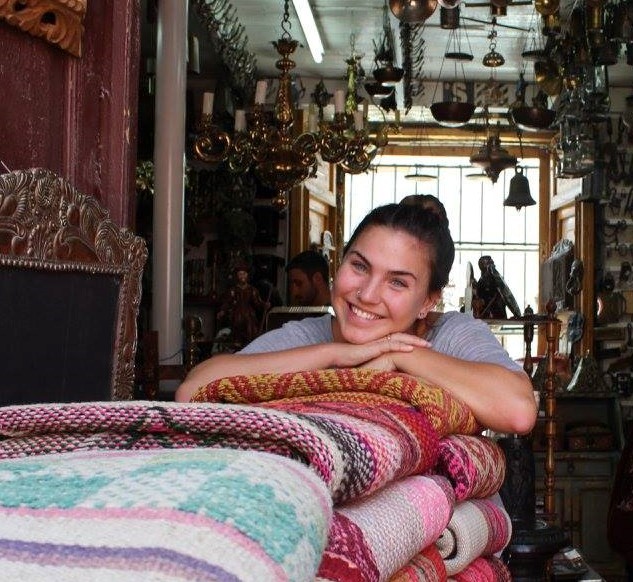 Della smiling in the back of textiles