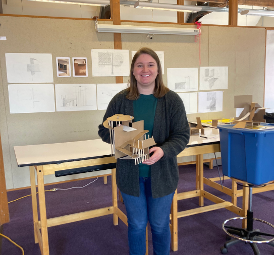 Catherine Hale, BLA'25, holds an architectural building model.
