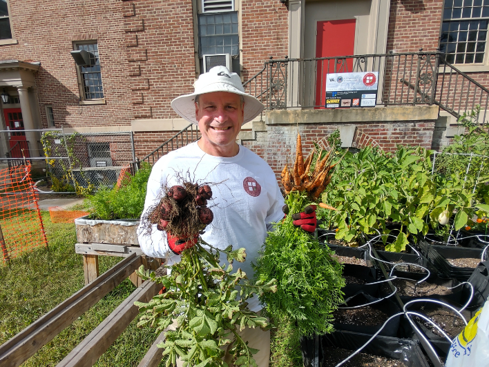 David Wilkins holds newly harvested carrot bunches for the November 11th Foundation's first VA donation.