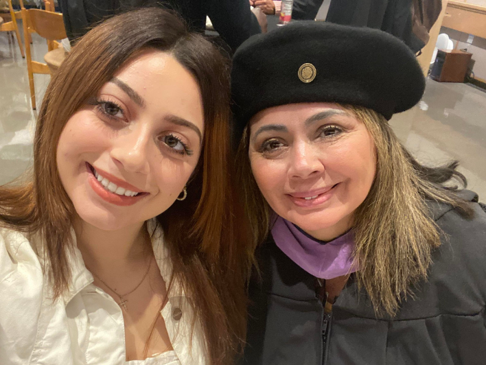 Haydée Hernandez, M.Arch'23, takes a selfie with her daughter, Sophia (left), during her graduation at the BAC 2023 Commencement.