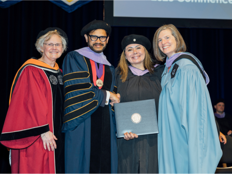Haydée Hernandez, M.Arch'23, receives her diploma at the 2023 Commencement. L to R: Judy Nitsch, BAC Board Chair, Mahesh Daas, BAC President, Haydée Hernandez, M.Arch'23, and Karen Nelson, Dean of the School of Architecture.