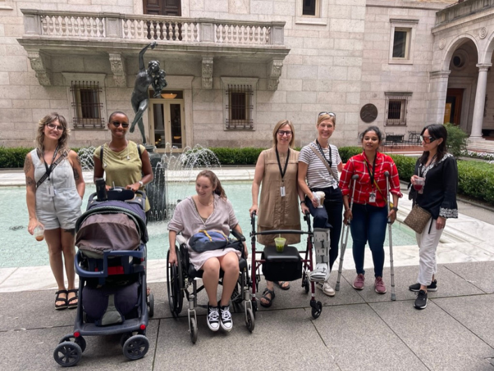 MDS-DHH students at Boston Public Library during Intensives week experiencing navigating the built environment with accessiblity equipment.