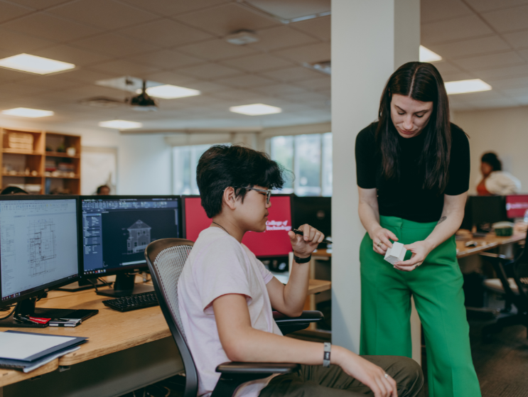 Jana teaching a student using a small model.