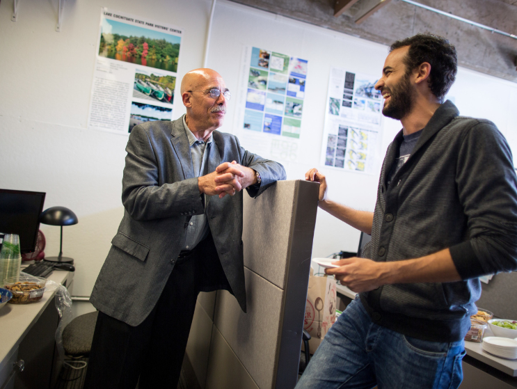 Len Charney speaks with a student at a Practice Open House during his tenure as the Dean of Practice at the BAC.