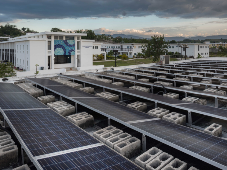 PV solar microgrid installation upgrade at Hôpital Universitaire de Mirebalais (HUM) in Haiti. The system provides annual savings of over $900,000 in diesel fuel costs that can be reallocated toward hospital operations.