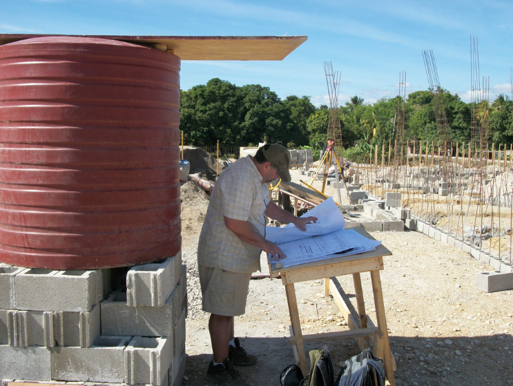 Jim reviews drawings during the construction of the new Hôpital Universitaire de Mirebalais (HUM) in Haiti in 2012.