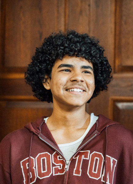 Jean Morales, a Summer Academy and UDP student in a maroon 'Boston' sweatshirt, chats with Dragana Bogavac, Pre-College Director, in a wood-paneled hallway during the program.