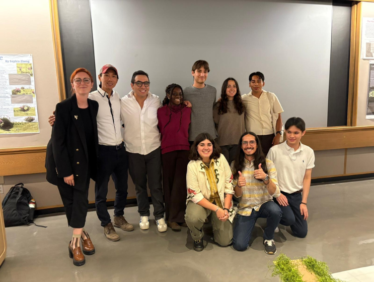 Bazam, a Summer Academy Teaching Assistant, takes a group photo with their Pre-College students after a presenation.