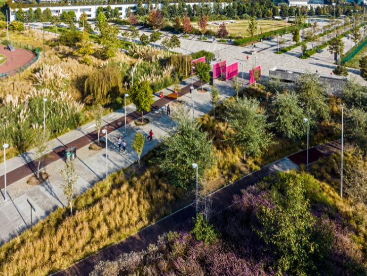 La Mexicana Park in Mexico City includes tree-lined paths, native plantings, plazas, and colorful structures within a large contemporary urban park.